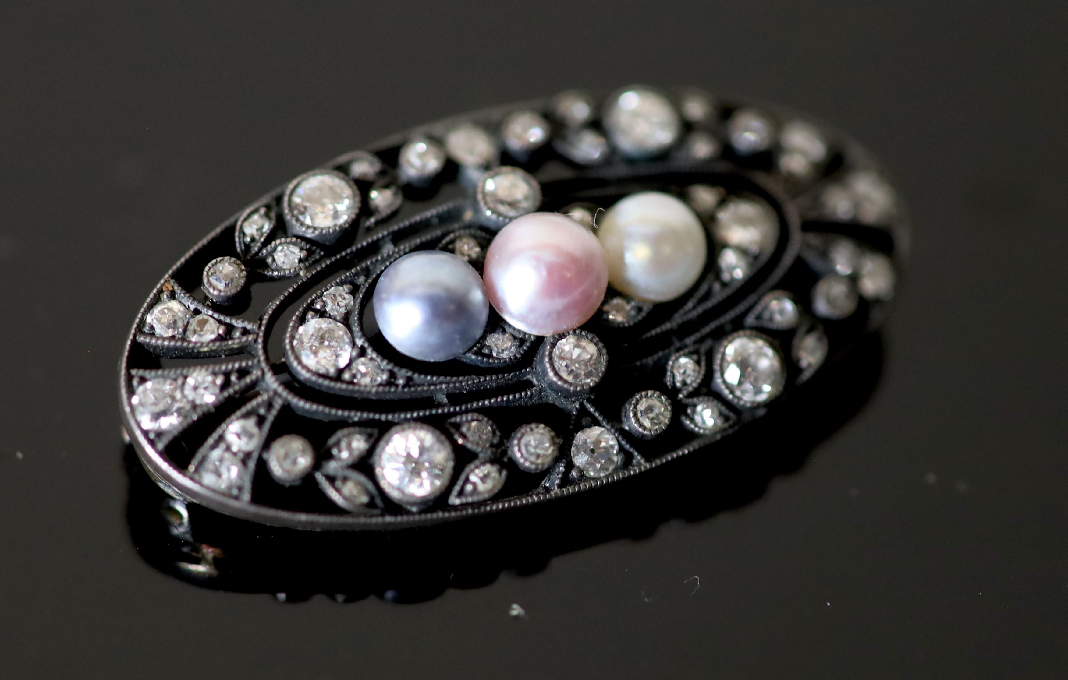 An early 20th century gold and silver, diamond and three colour split pearl set oval openwork brooch,